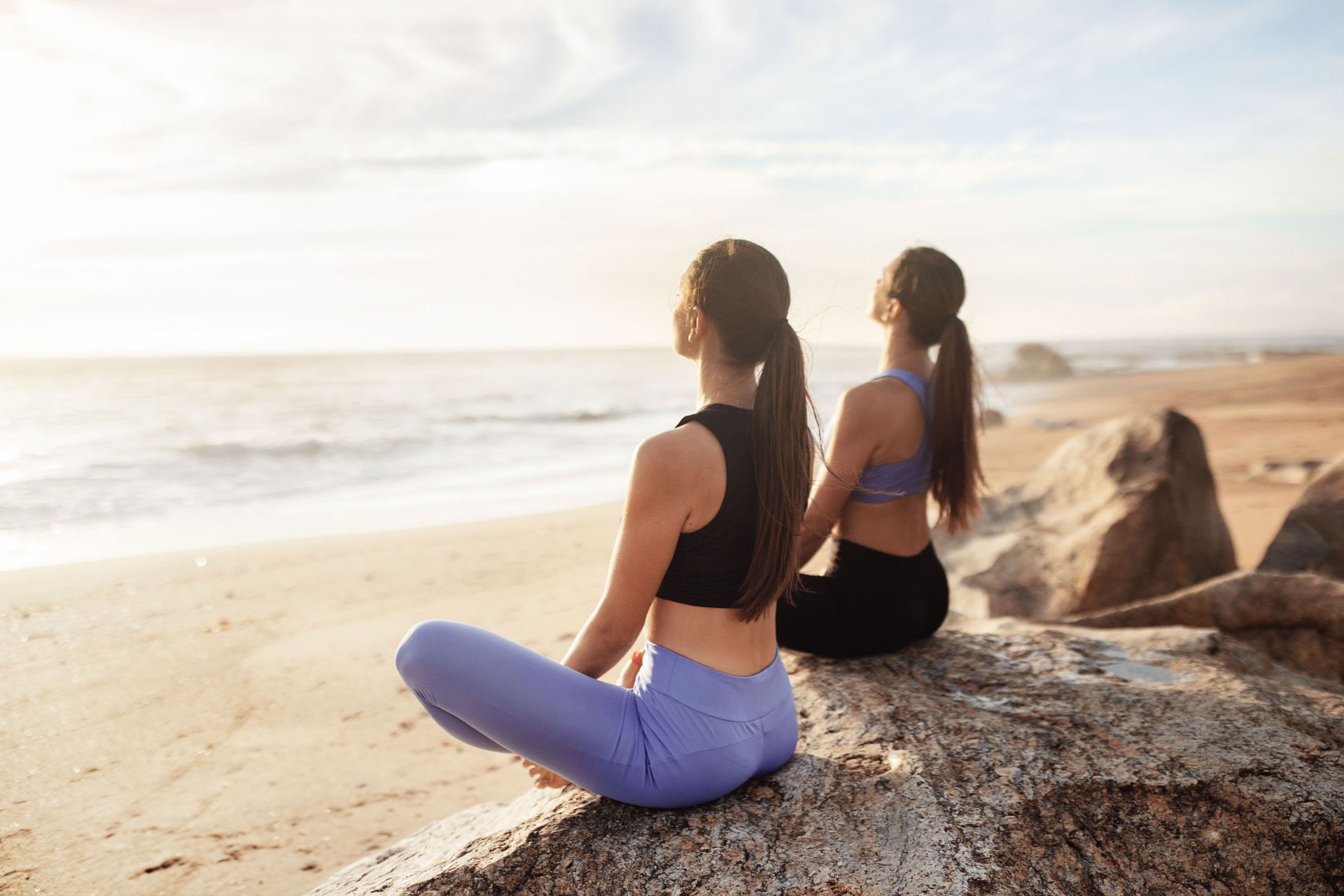 Calm glad young caucasian women enjoy morning workout, breathing exercises, meditation, practice yoga